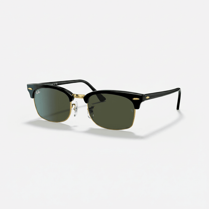 Ray-Ban Clubmaster sunglasses with a black acetate front, gold metal bridge and temple accents, and green-tinted lenses, shown on a light gray background.