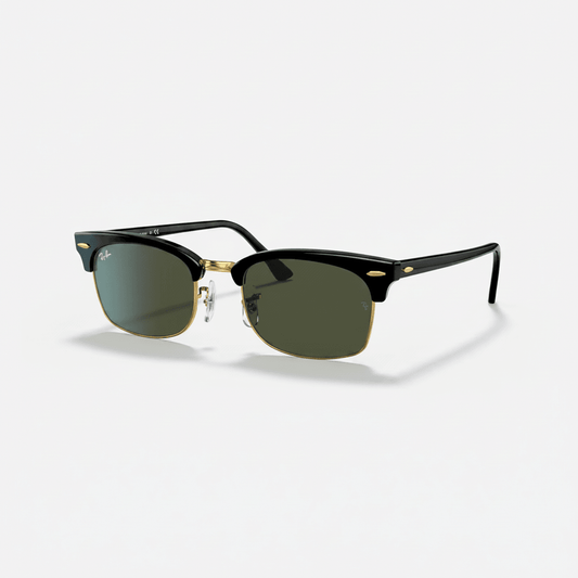 Ray-Ban Clubmaster sunglasses with a black acetate front, gold metal bridge and temple accents, and green-tinted lenses, shown on a light gray background.